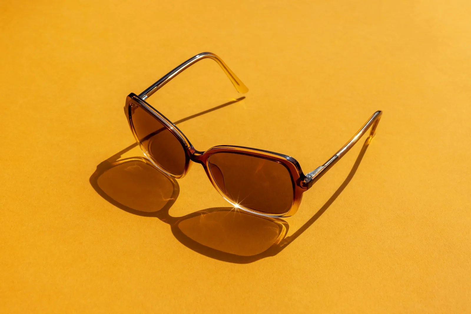Sunglasses on a table, illustrating light sensitivity in the first weeks.