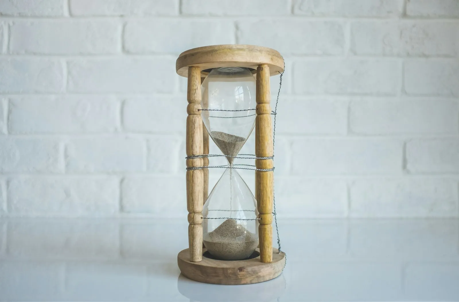 Sand running through a timer, illustrating the months before revision is judged.